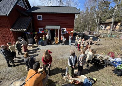 A group gathering in a circle outside the café